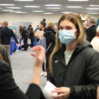 Two faculty discuss with student